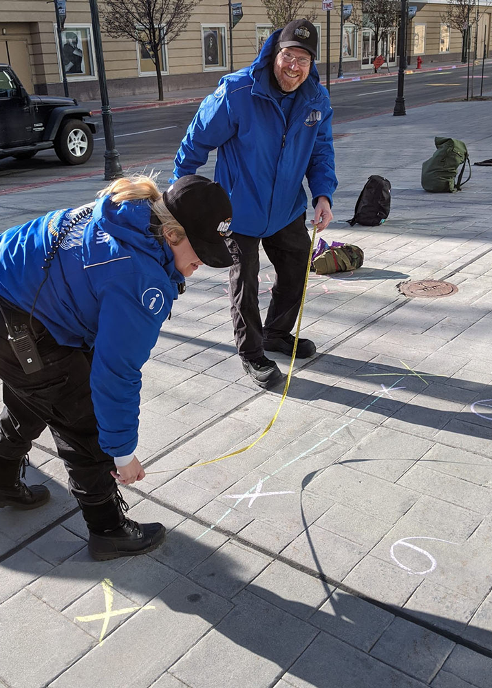 Covid- ambassadors marking 6 feet on sidewalk