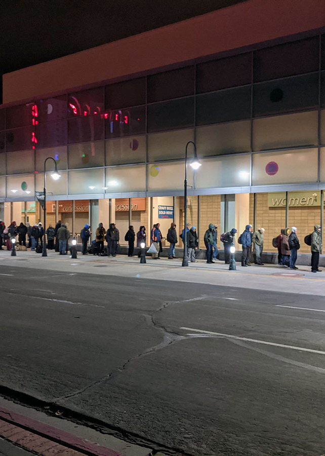 People in line waiting in line for shelter during the Covid-19 pandemic.