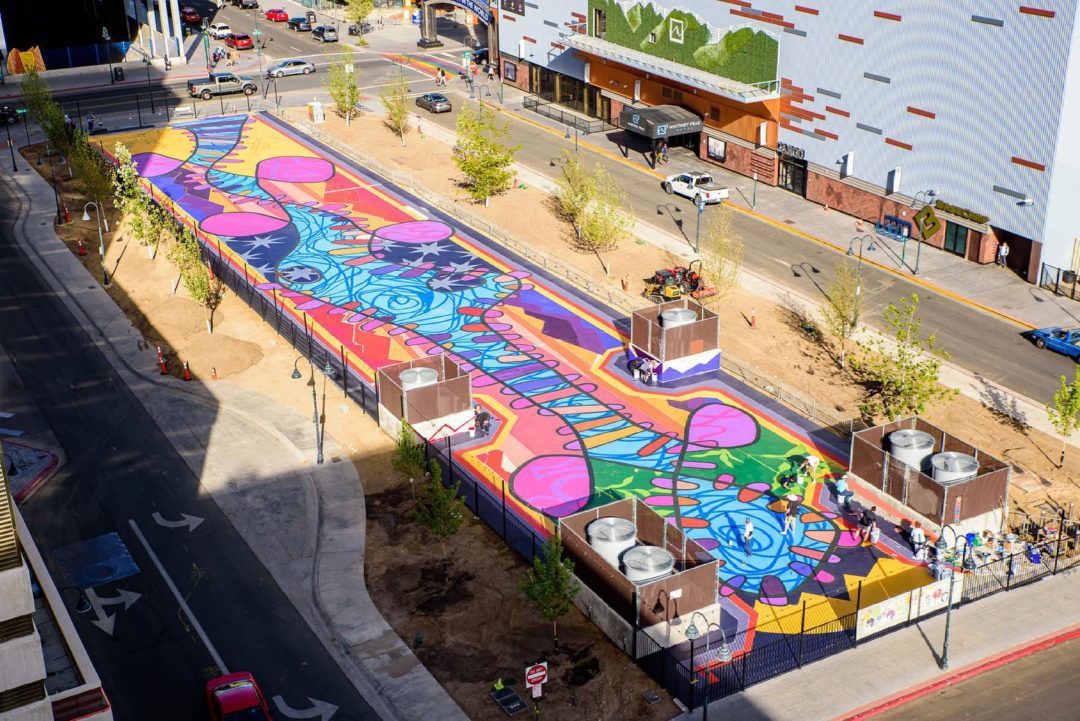 Aeriel view of the mural on Locomotion Plaza. There are colors of pink , blue, purple, green, yellow, orange, and red.