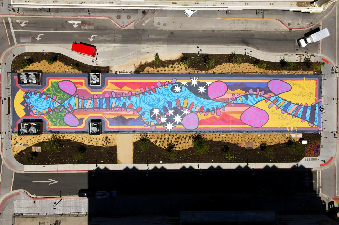 Aeriel view of the mural on Locomotion Plaza. There are colors of pink , blue, purple, green, yellow, orange, and red.