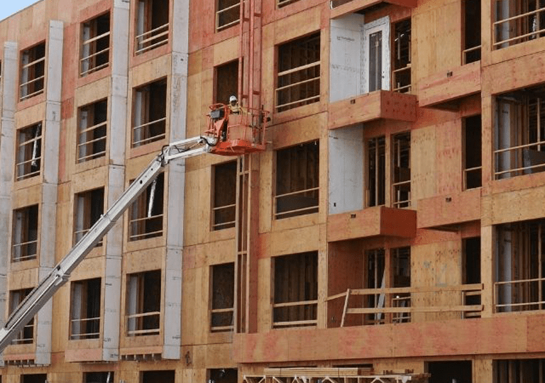 Construction workers working on the Apartment project near the ballpark.