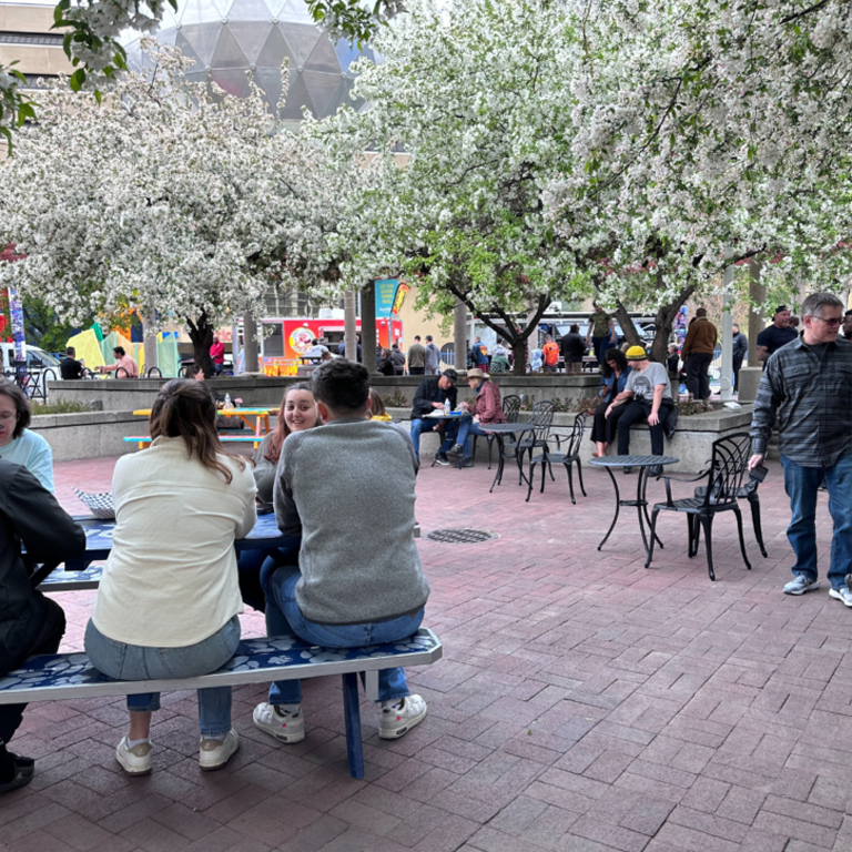 People sitting at the Partnership Plaza enjoying Downtown Tuesdays.