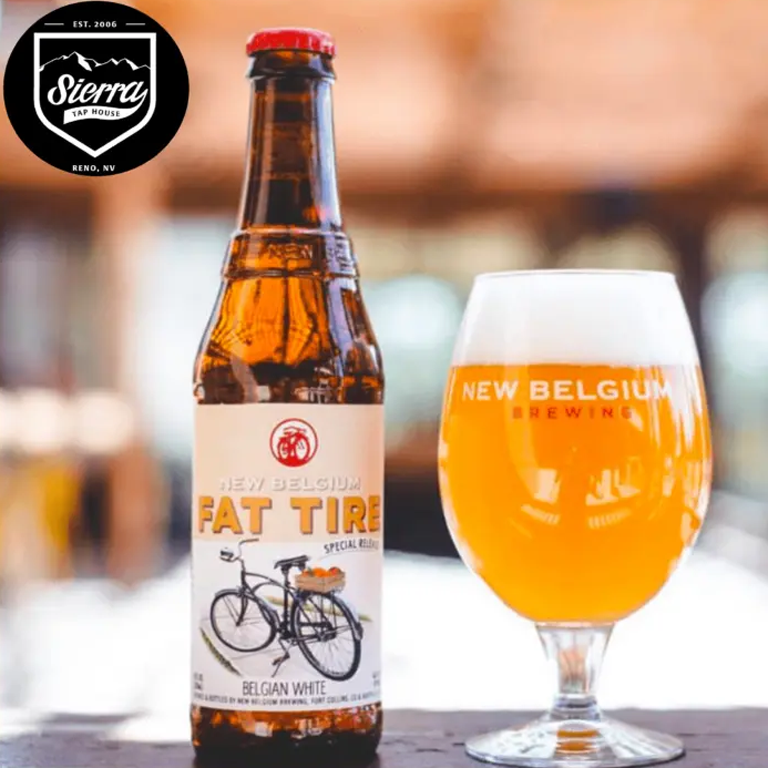 New Belgium Fat Tire beer bottle with a glass of beer next to it.