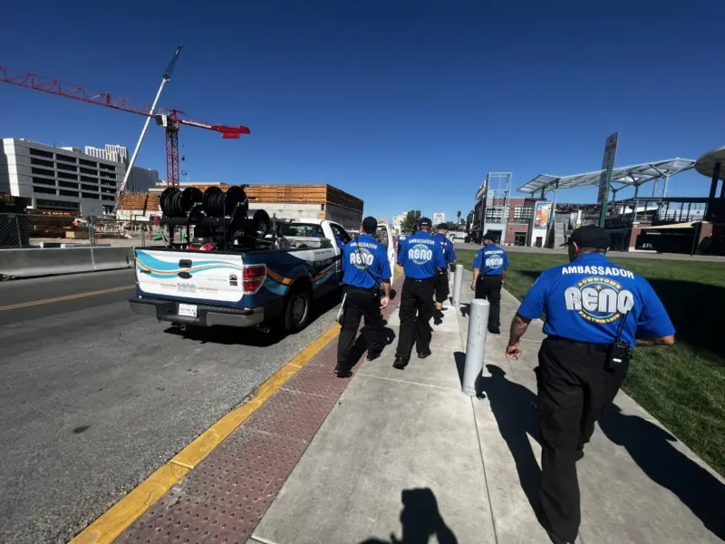 Ambassadors walking downtown near the Greater Nevada Field. Parked next to them is their branded white truck.